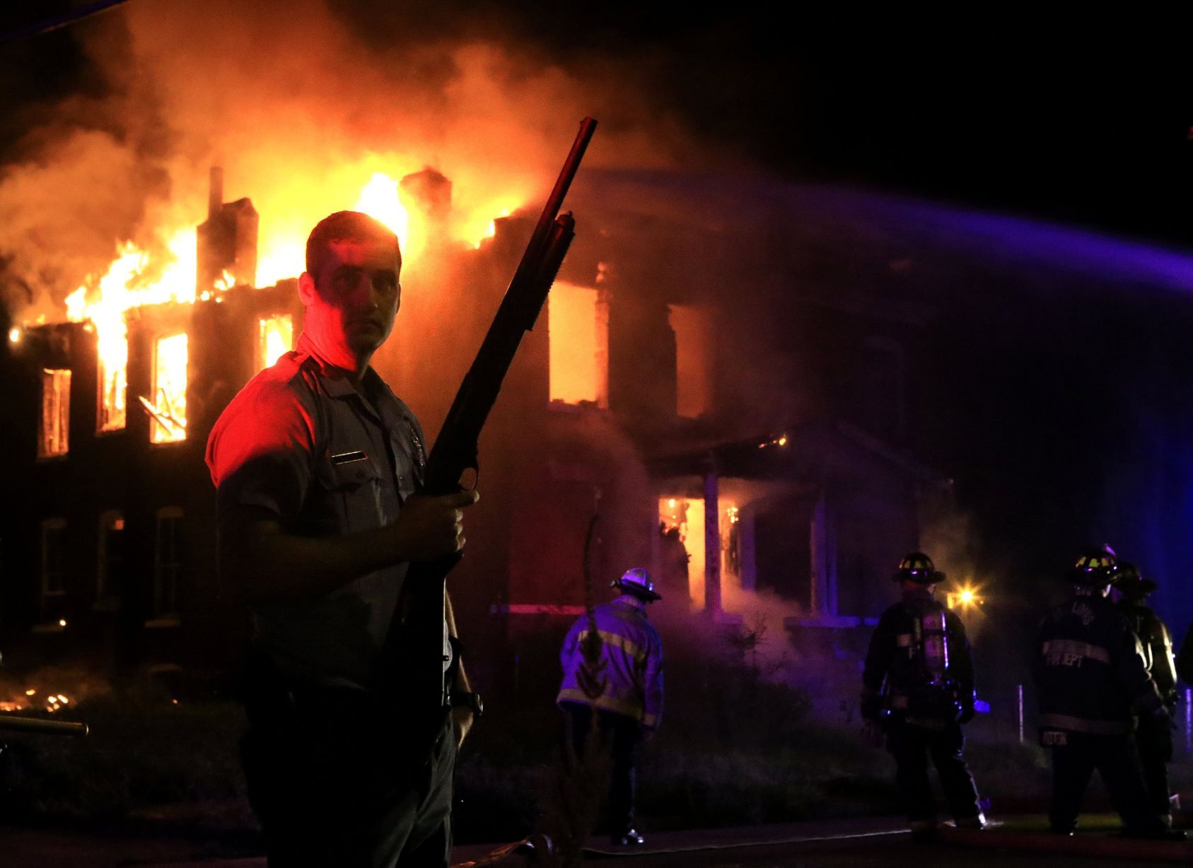 Officer guards firefighters at burning house on Bayard